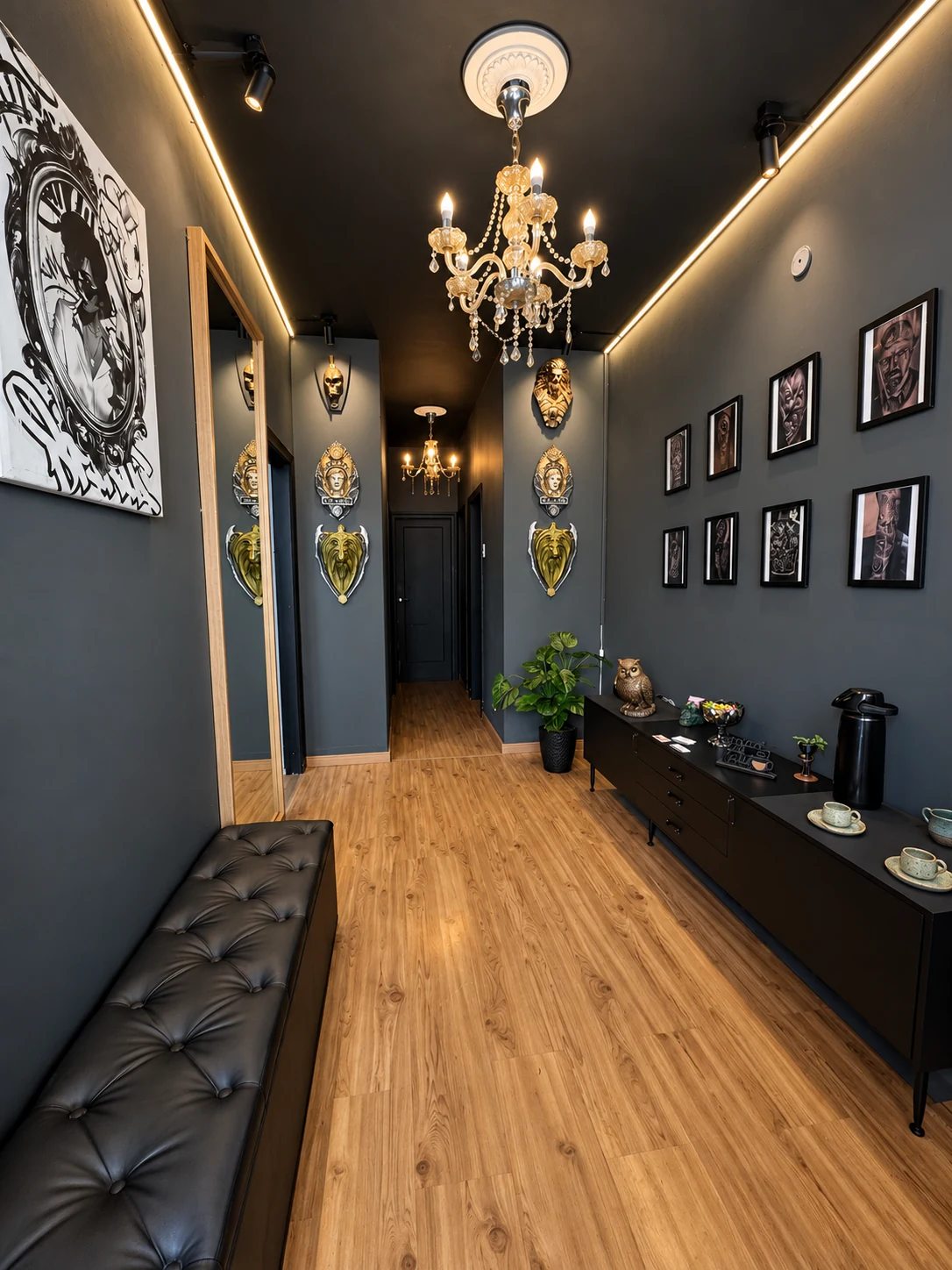 Corredor do estúdio com lustre, quadros, banco e espaço para café